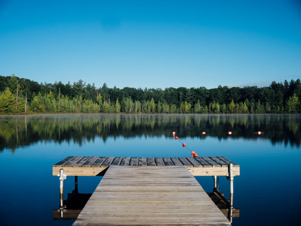 Quiet New Hampshire lake and dock near Windham, NH, where Vorenza delivers rental cars